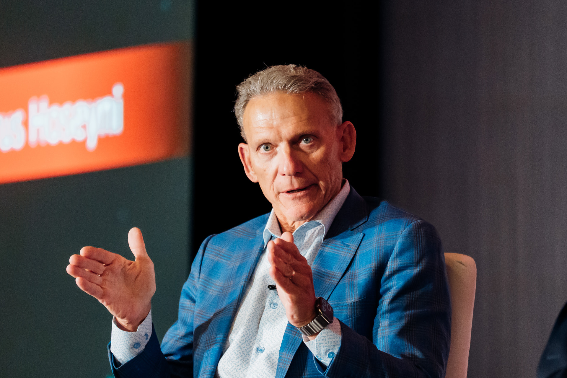 Corporate event photography of an executive speaking and gesturing at a corporate event in Tampa Bay