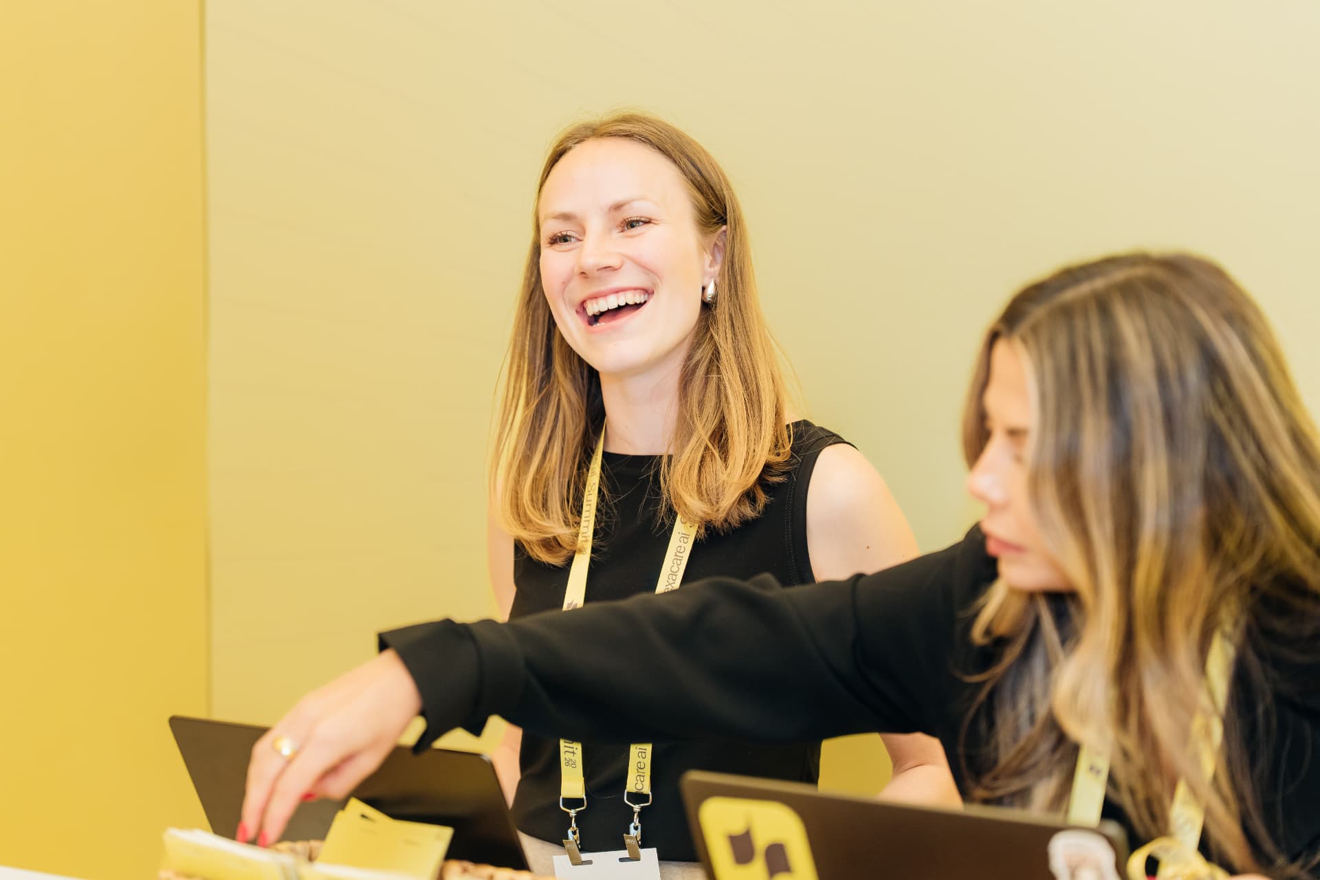 Corporate event photography of event staff at a Miami conference registration desk