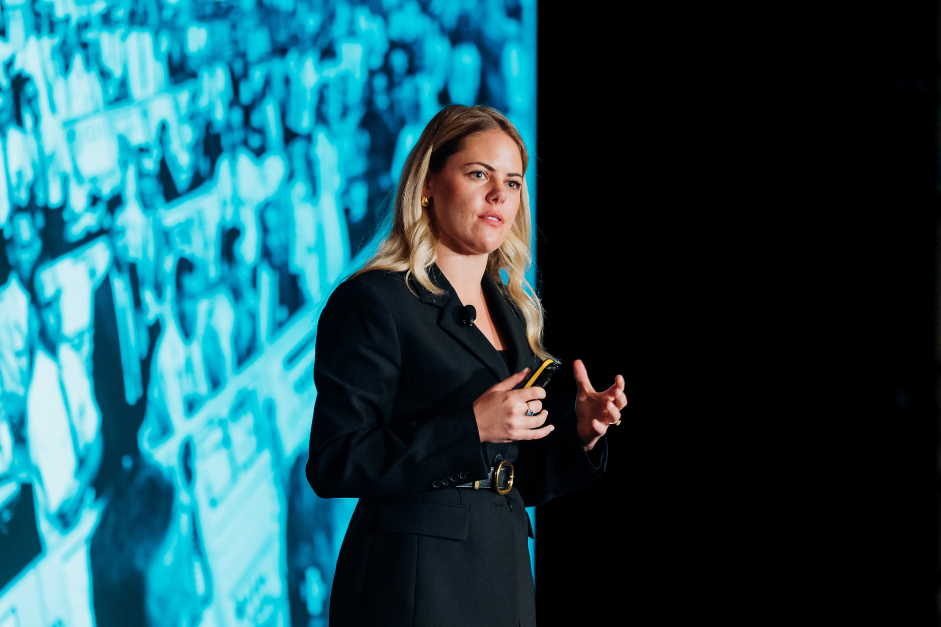 Corporate event photography of a keynote speaker presenting on stage at a conference in Tampa