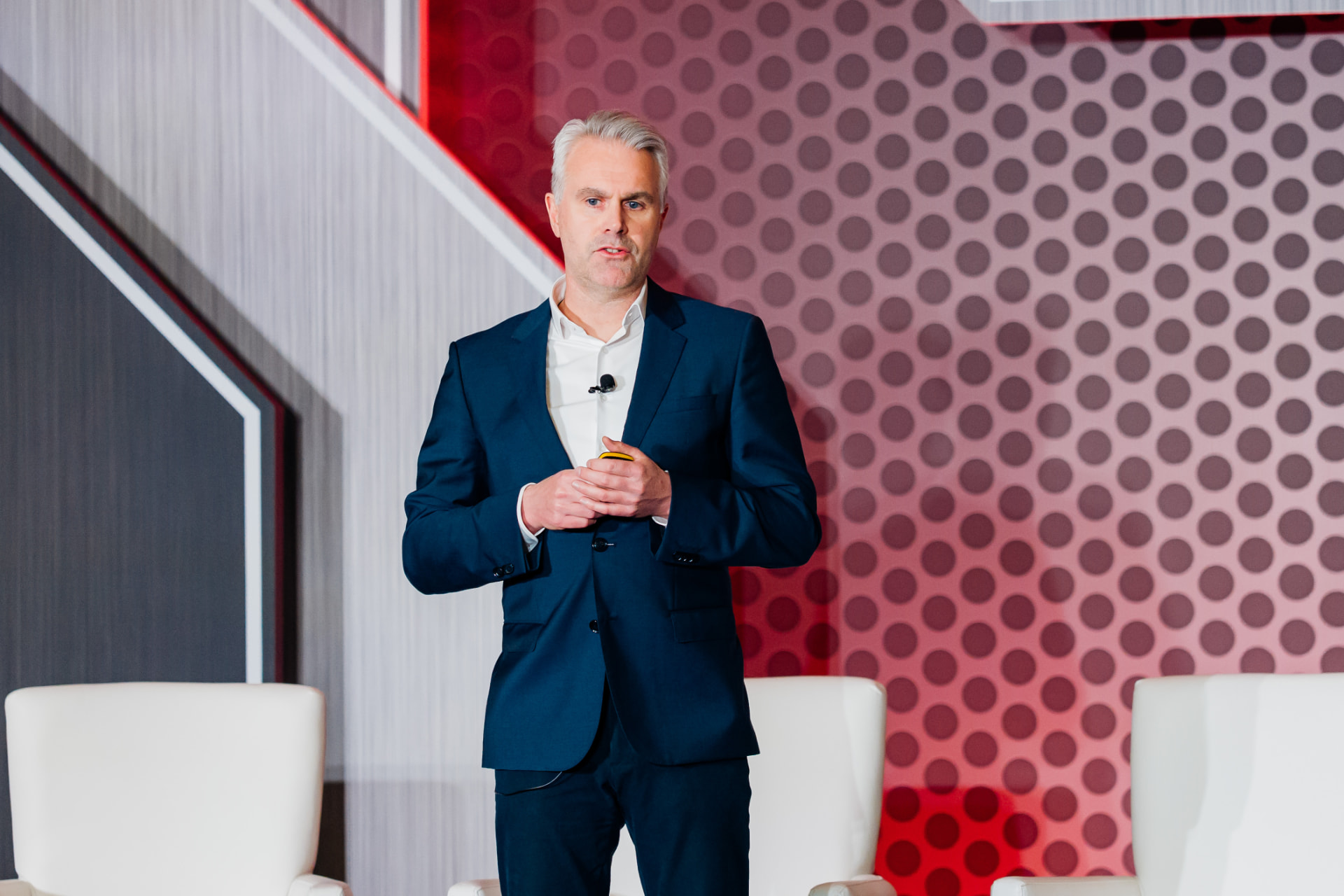 Keynote speaker presenting on stage at a corporate conference in Miami
