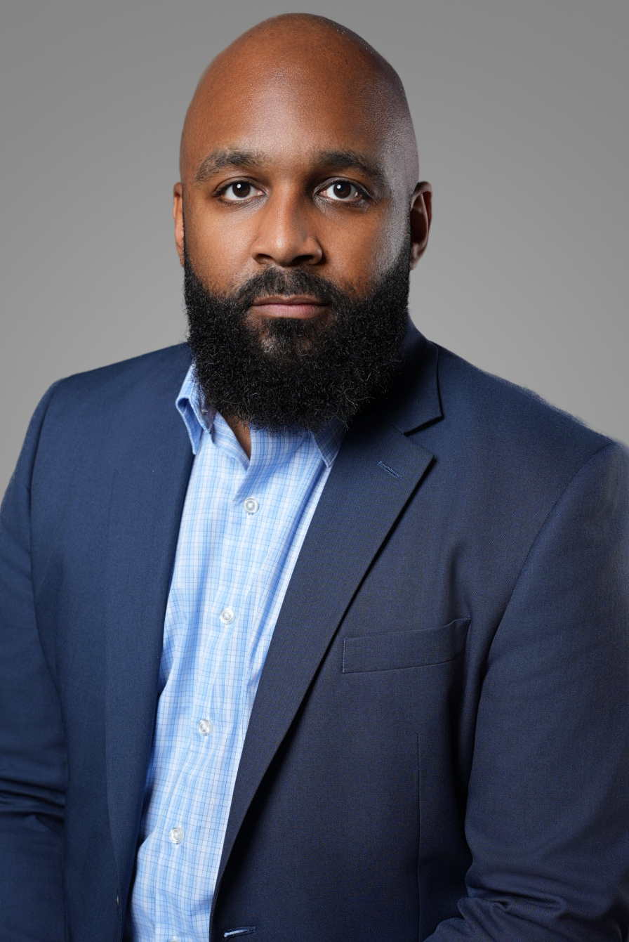 Professional personal branding portrait of a man in a navy suit and light blue checked shirt — Endless Visuals Tampa corporate headshots