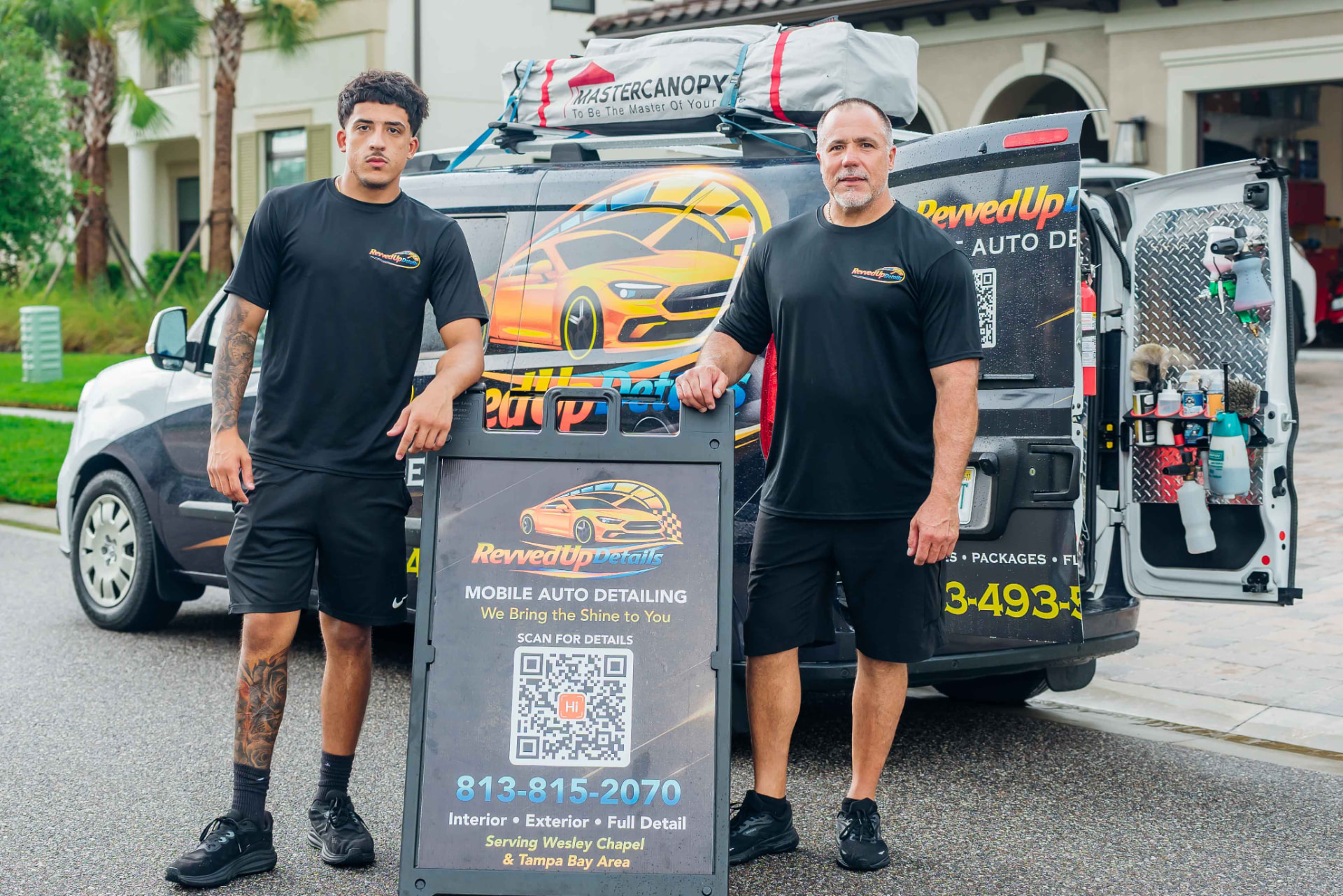 Corporate branding video production featuring uniformed staff beside a branded mobile detailing van with promotional signage — Endless Visuals Tampa Bay commercial and branding video production