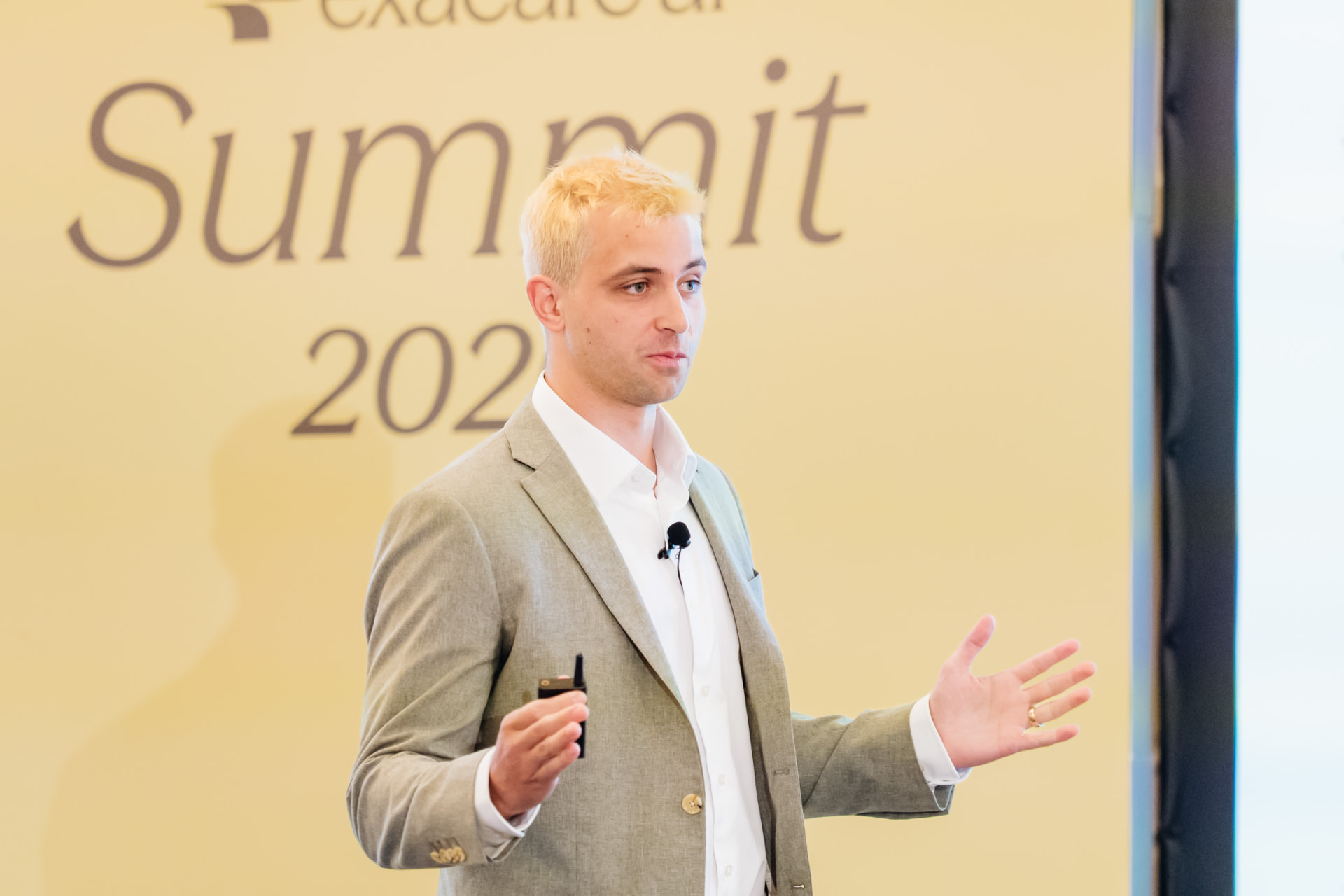 Corporate event photography of a keynote speaker presenting at a Miami summit