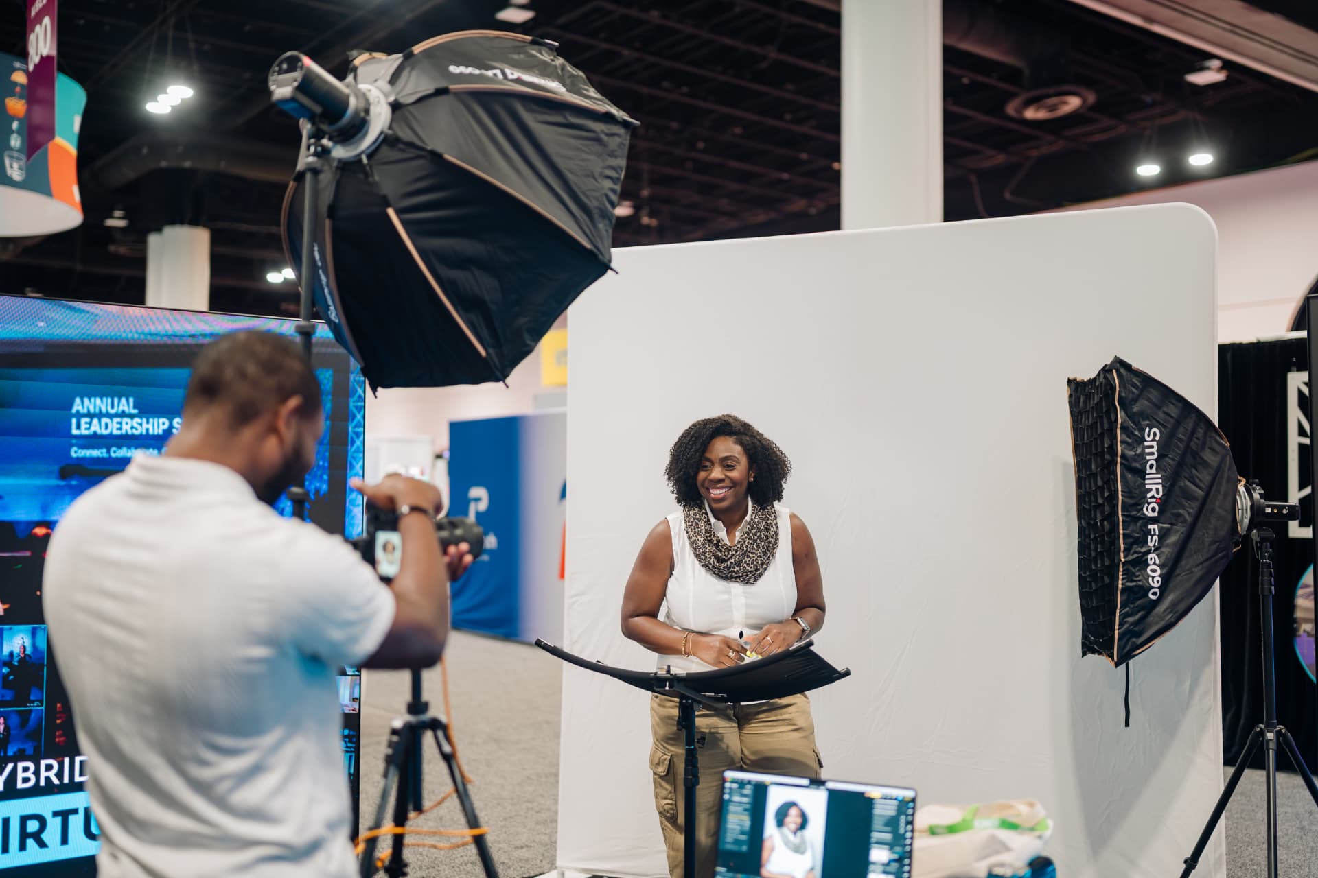 Endless Visuals photographer capturing an executive headshot at a corporate conference headshot booth with professional softbox lighting and a seamless white backdrop — Tampa Bay on-site corporate headshots