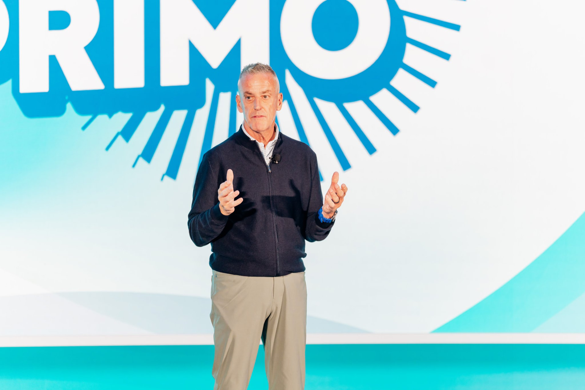 Corporate photography of an executive presenting on stage at a general session