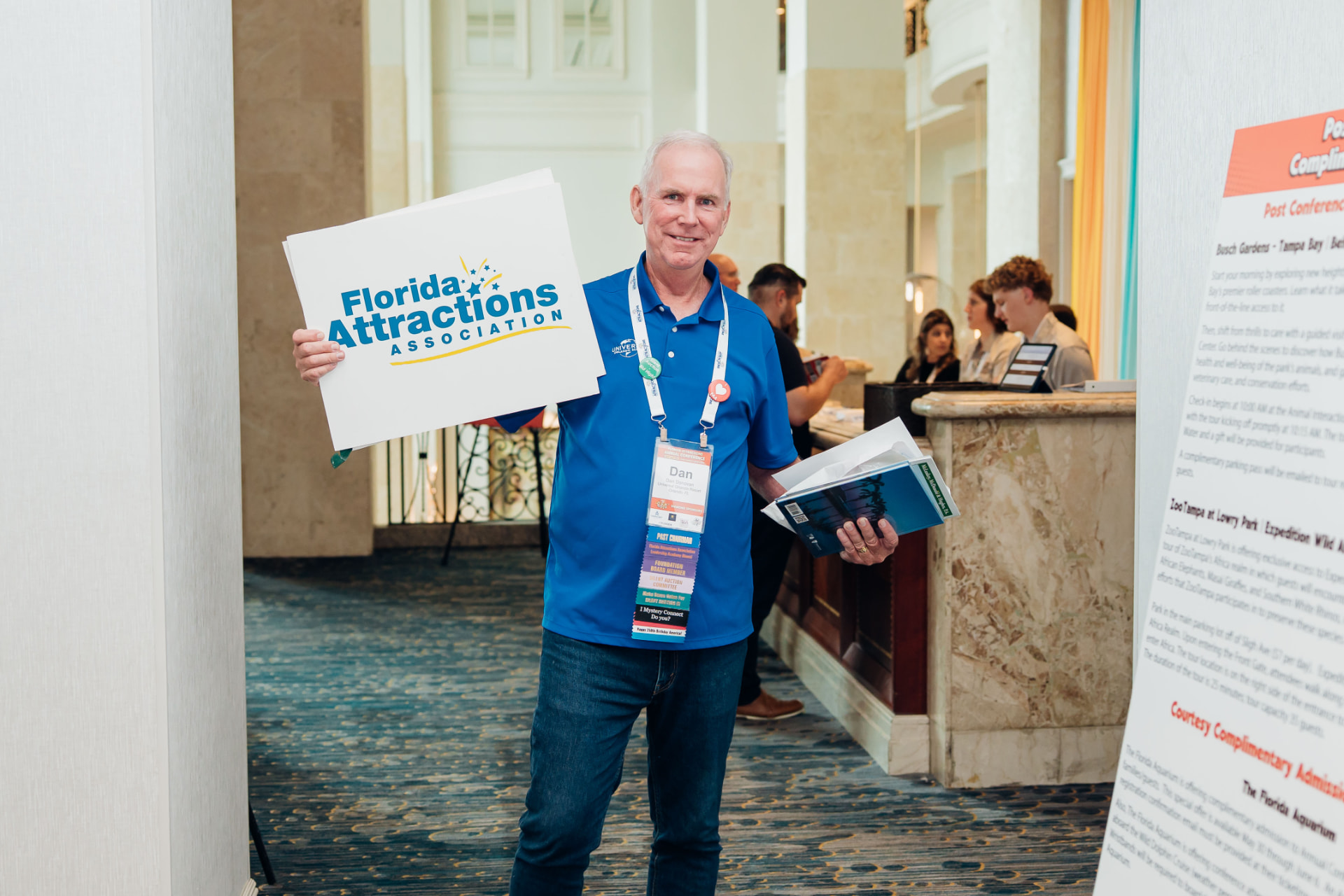 Corporate event photography of an attendee holding an association sign at a Florida conference