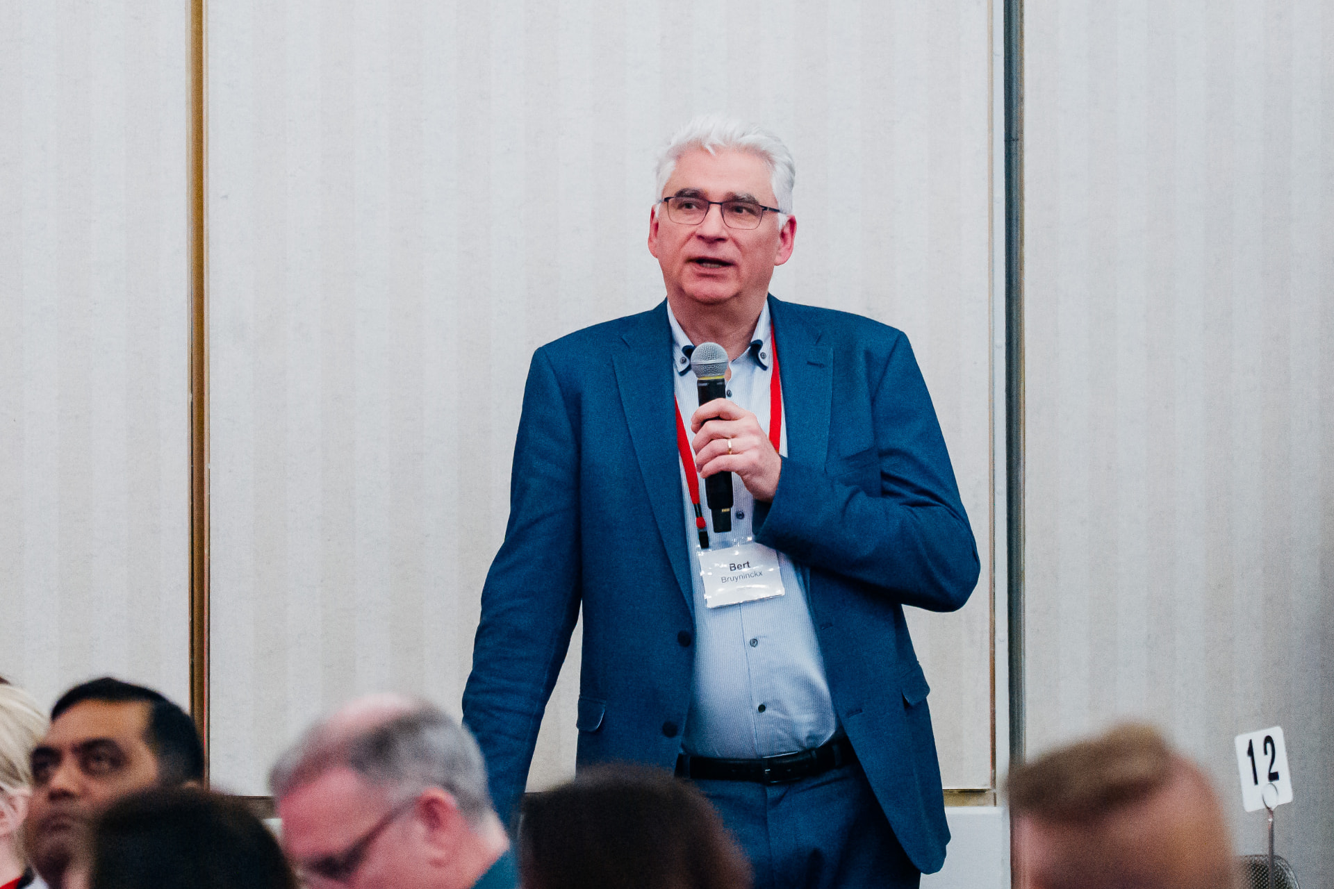Corporate event photography of an executive addressing the room at a Miami meeting